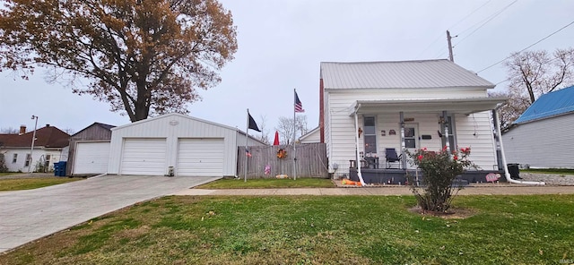 view of front of property featuring an outbuilding, a porch, a garage, and a front lawn