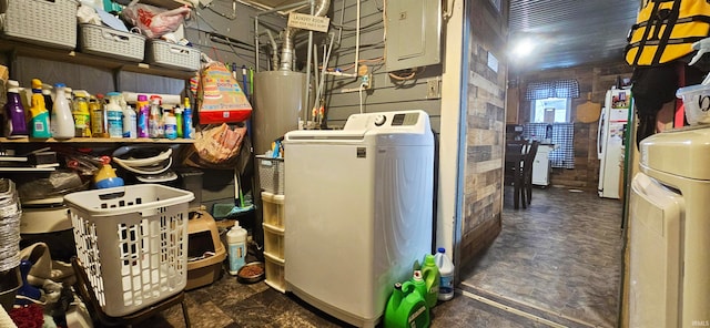 utility room with electric panel, washer / clothes dryer, and water heater