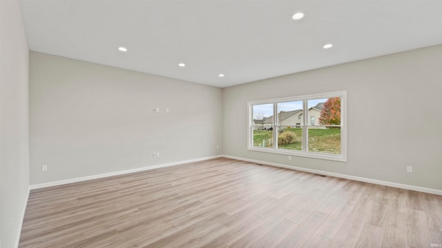 unfurnished room with light wood-type flooring