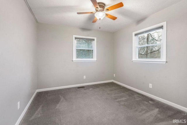 unfurnished room featuring ceiling fan, carpet, and a textured ceiling