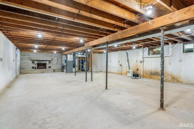 basement featuring a fireplace and gas water heater