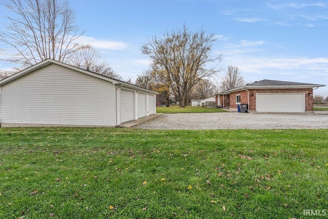 view of side of property featuring a yard and a garage