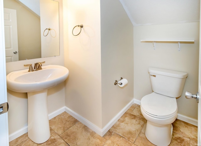 bathroom featuring sink, tile patterned flooring, lofted ceiling, and toilet