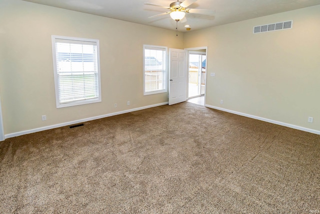 carpeted spare room featuring ceiling fan