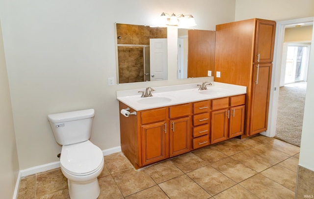 bathroom with tile patterned flooring, vanity, an enclosed shower, and toilet