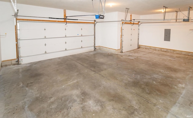 garage with electric panel and a garage door opener