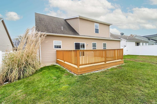 back of house featuring a yard and a deck