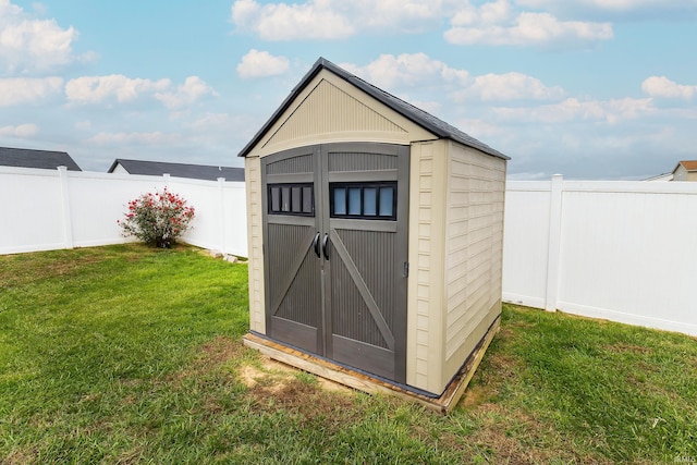 view of outbuilding with a yard