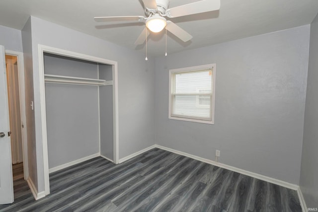 unfurnished bedroom with dark hardwood / wood-style flooring, a closet, and ceiling fan