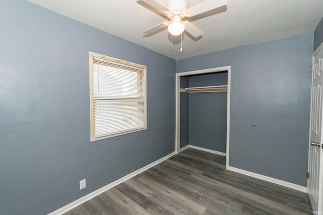 unfurnished bedroom featuring ceiling fan, a closet, and dark hardwood / wood-style floors