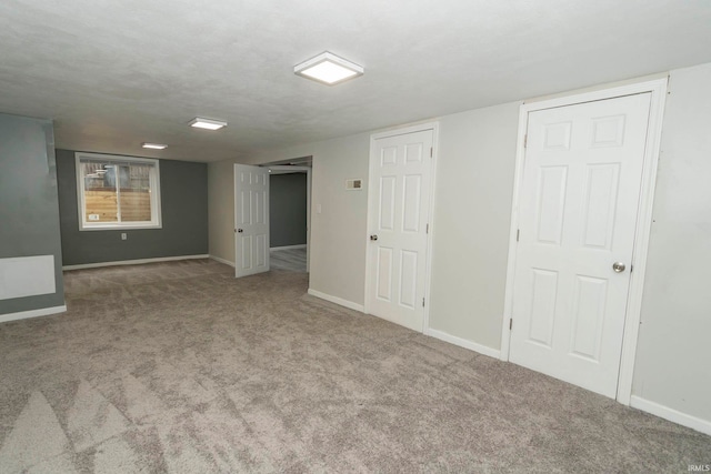 basement with carpet flooring and a textured ceiling