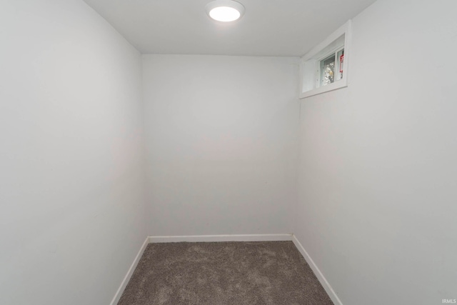 spare room with dark carpet