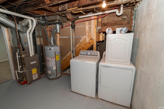 washroom with washing machine and dryer, water heater, and heating unit