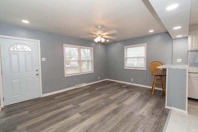 foyer with plenty of natural light, ceiling fan, and dark hardwood / wood-style flooring