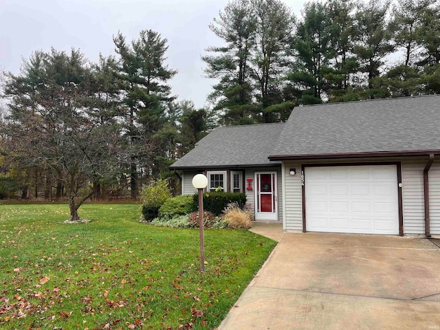 view of front facade with a front yard and a garage