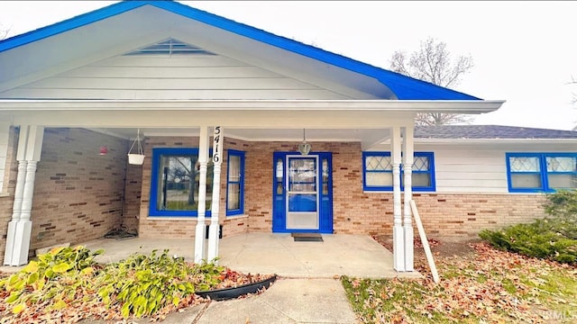 view of exterior entry featuring a porch