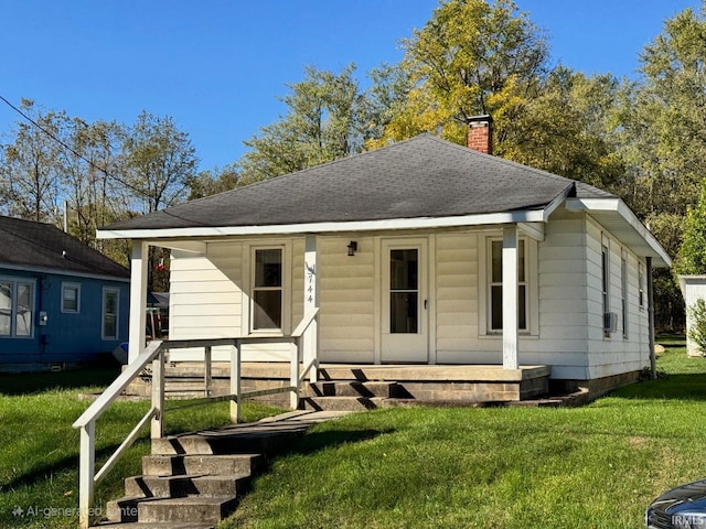 view of front of home with a porch and a front yard