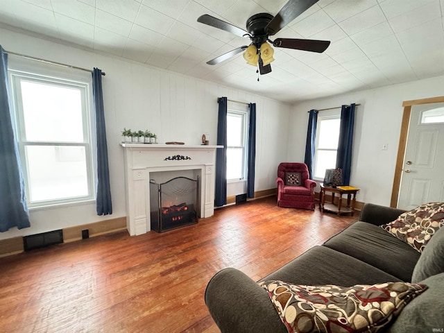 living room with hardwood / wood-style floors and ceiling fan