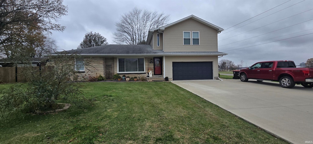 view of property featuring a front yard and a garage