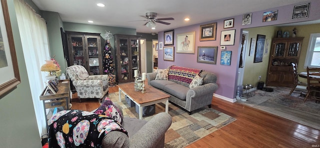 living room with wood-type flooring and ceiling fan