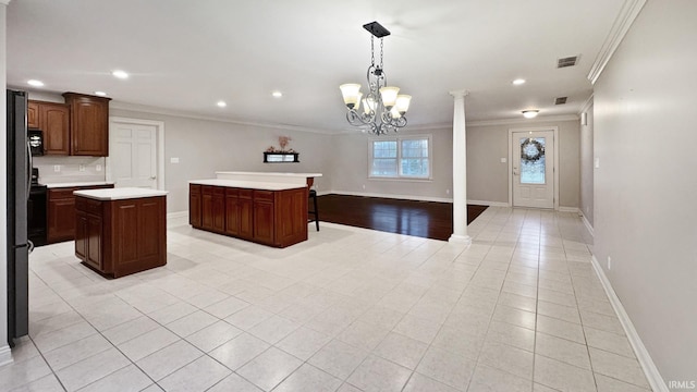 6777 Oak Grove Rd, Newburgh, IN 47630 - kitchen with ornamental molding, a kitchen island, light countertops, recessed lighting, and baseboards