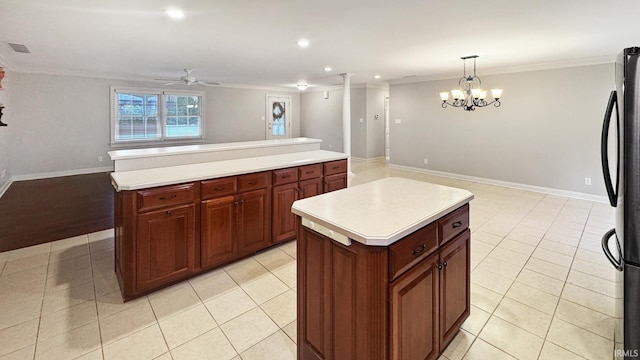 6777 Oak Grove Rd, Newburgh, IN 47630 - kitchen with a center island, open floor plan, freestanding refrigerator, ceiling fan, and ornamental molding
