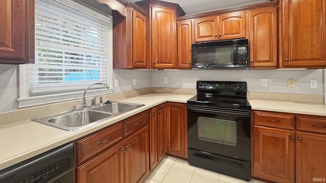 6777 Oak Grove Rd, Newburgh, IN 47630 - kitchen with black appliances, a sink, light countertops, light tile patterned floors, and brown cabinetry