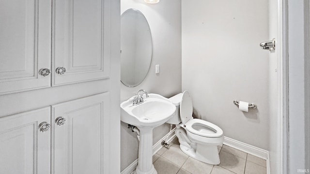 6777 Oak Grove Rd, Newburgh, IN 47630 - bathroom with baseboards, toilet, and tile patterned flooring