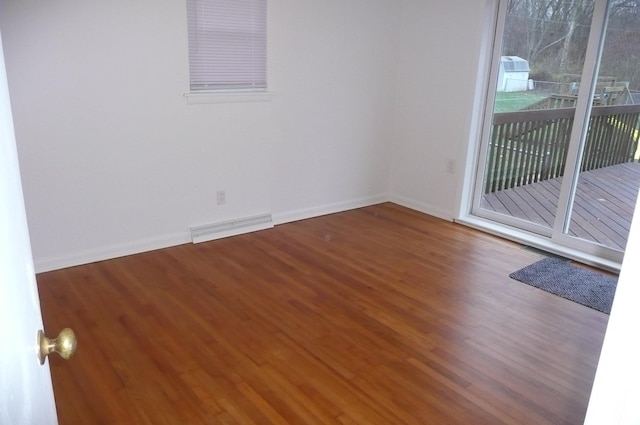 empty room with hardwood / wood-style floors