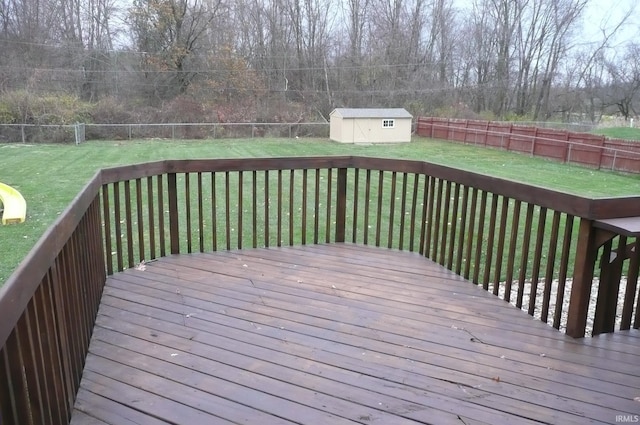 wooden terrace with a lawn and a storage unit