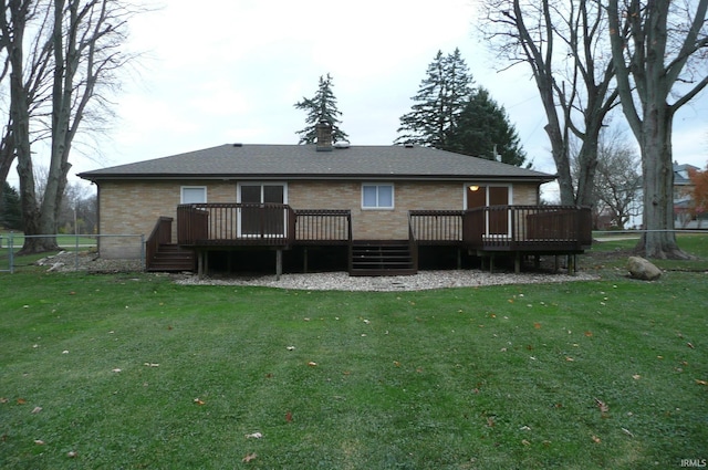 rear view of house featuring a yard and a deck