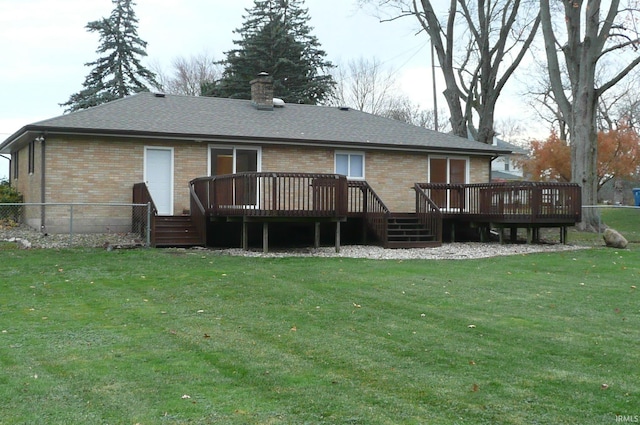 back of property with a lawn and a wooden deck