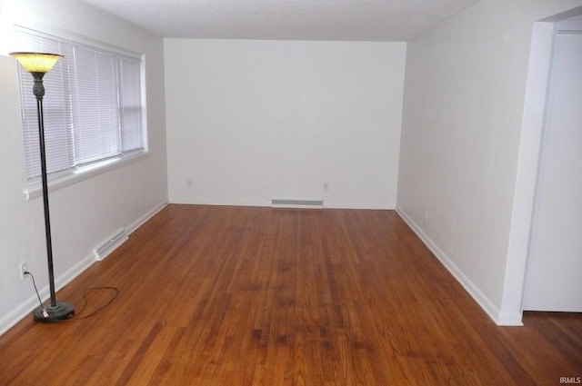 unfurnished room with dark hardwood / wood-style floors