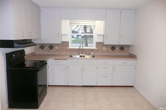 kitchen featuring black electric range, decorative backsplash, white cabinets, and sink