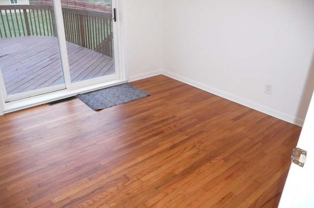 unfurnished room featuring hardwood / wood-style flooring