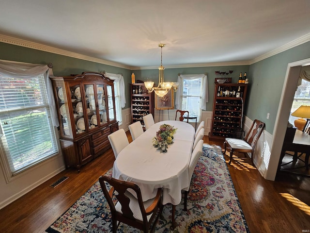 dining area with plenty of natural light, dark hardwood / wood-style floors, and ornamental molding