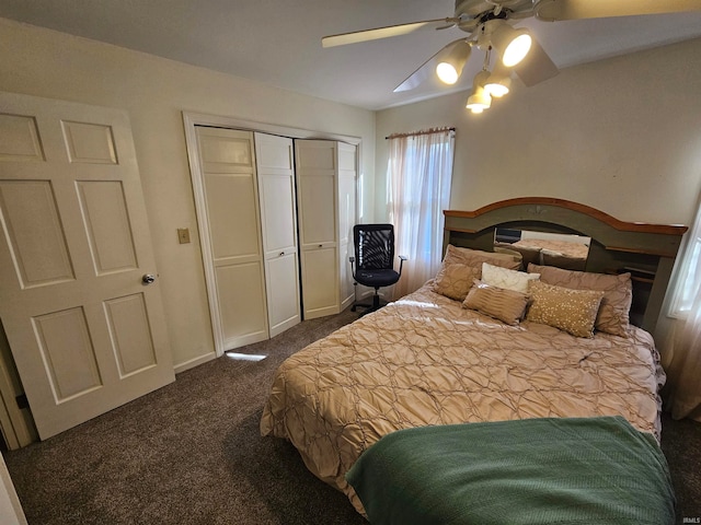 bedroom with ceiling fan, dark carpet, and a closet