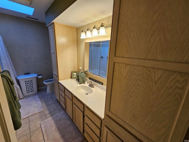 bathroom featuring tile patterned floors, vanity, and toilet