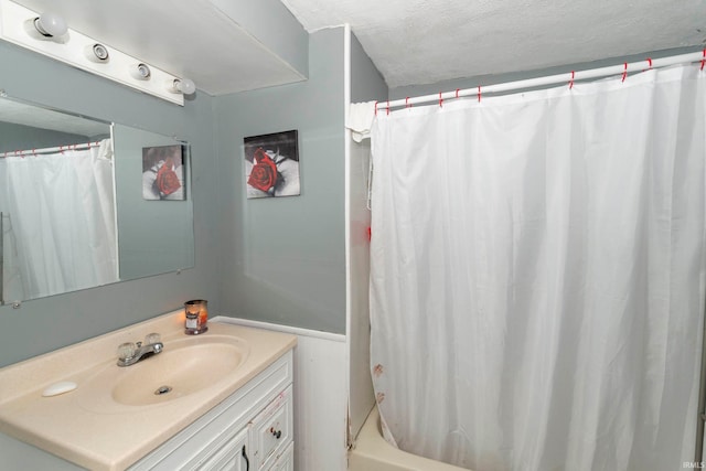 bathroom featuring a textured ceiling and vanity