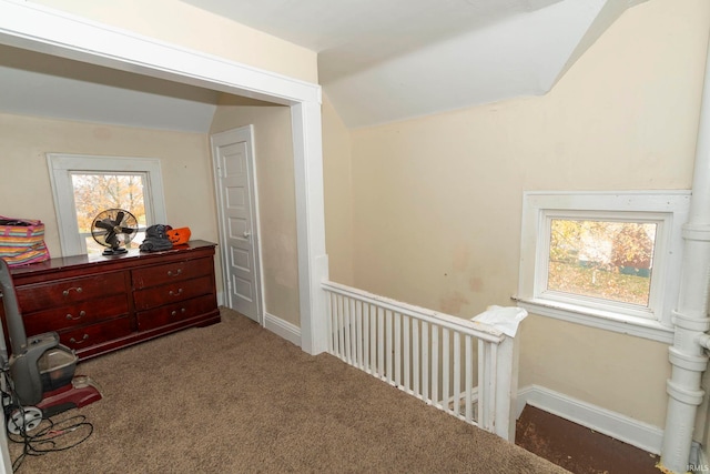 sitting room with dark carpet and vaulted ceiling