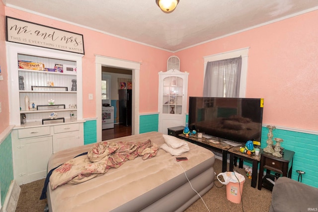 bedroom featuring a textured ceiling and crown molding