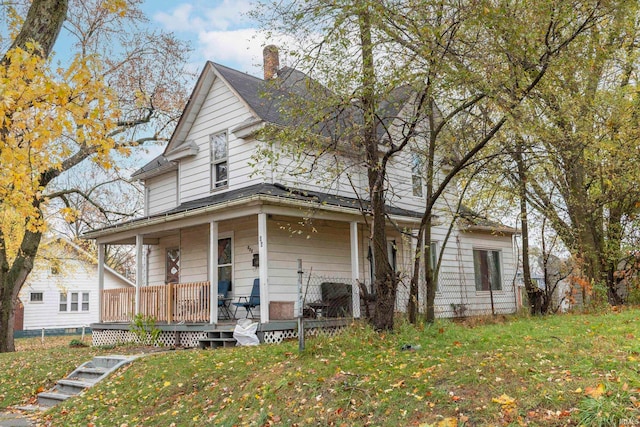 farmhouse with a front yard and a porch