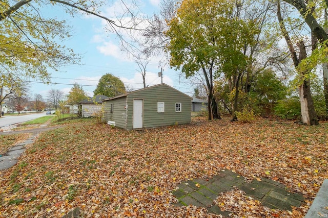 view of property exterior with an outbuilding