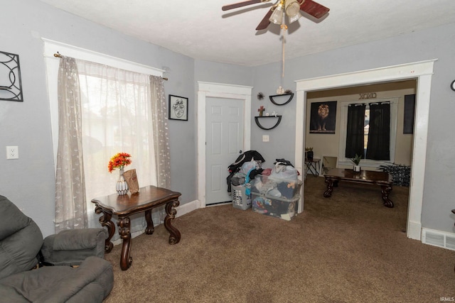 interior space with ceiling fan