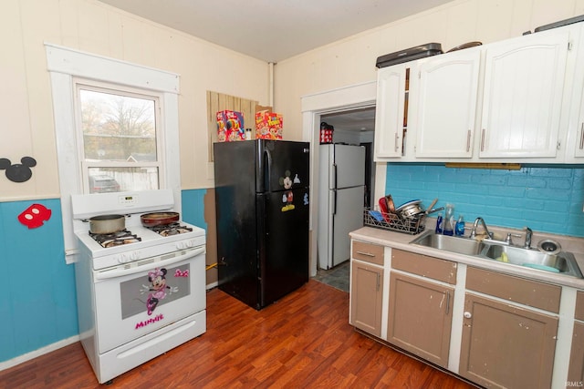 kitchen with white cabinets, dark hardwood / wood-style floors, white appliances, and sink