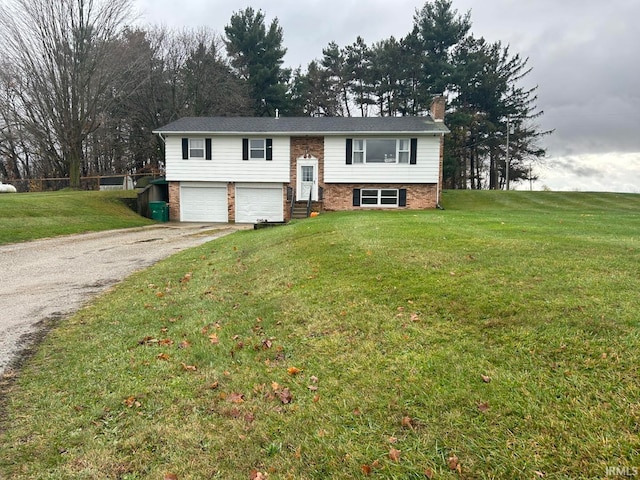 split foyer home with a garage and a front lawn