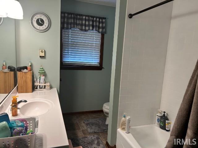 full bathroom featuring vanity, toilet, and tiled shower / bath