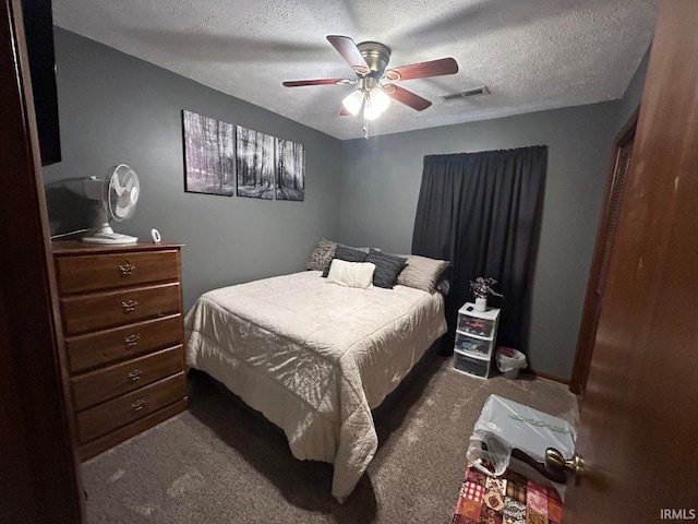 carpeted bedroom with a textured ceiling and ceiling fan