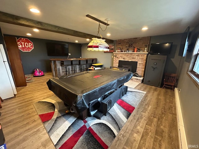 game room featuring hardwood / wood-style floors, bar area, a fireplace, pool table, and beamed ceiling