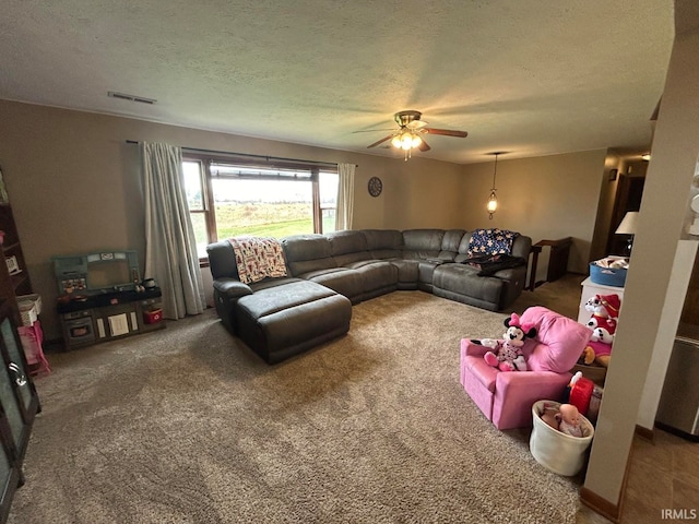 living room featuring carpet, a textured ceiling, and ceiling fan